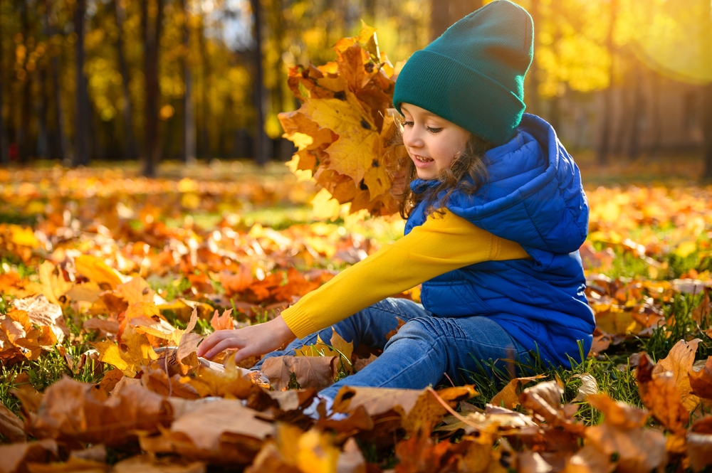 Child with autumn leaves
