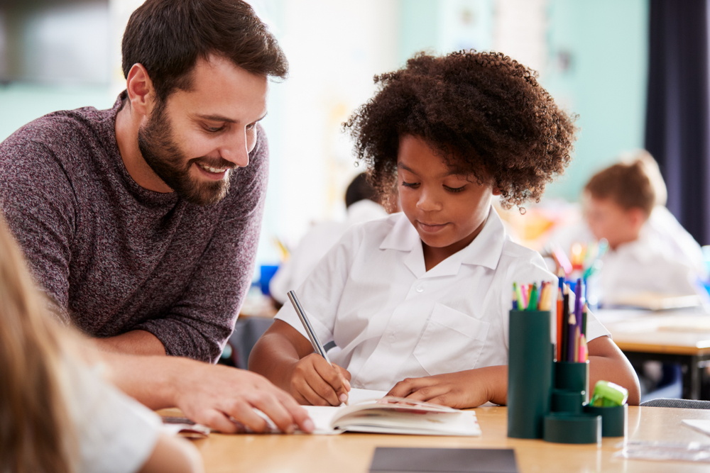 A SET teacher providing 1 to 1 in classroom support 