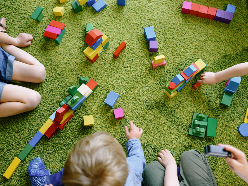 Children playing collaboratively with construction blocks