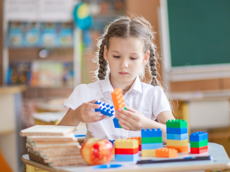 Older student playing with construction blocks